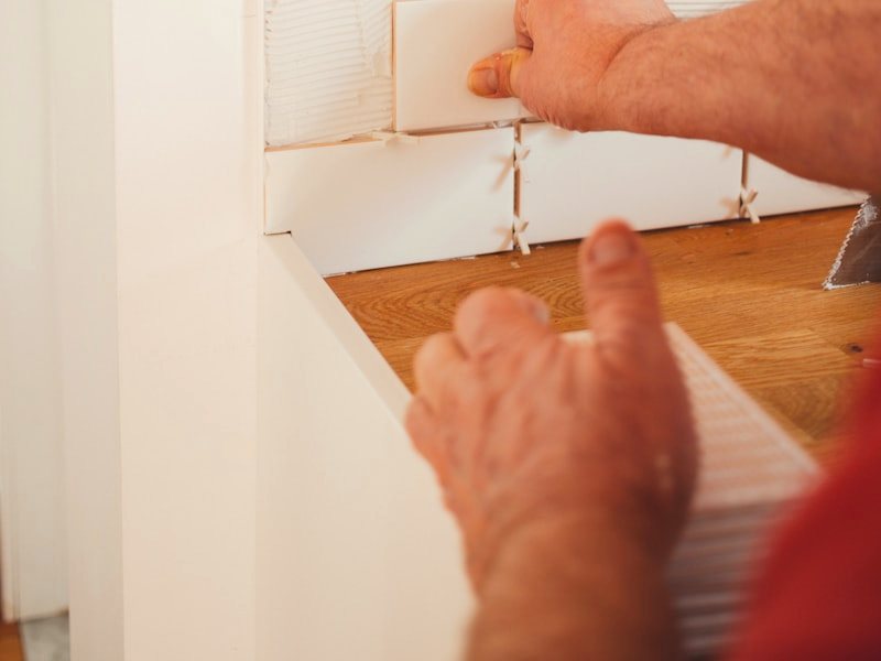 A painter working an edge by hand during surface preparation