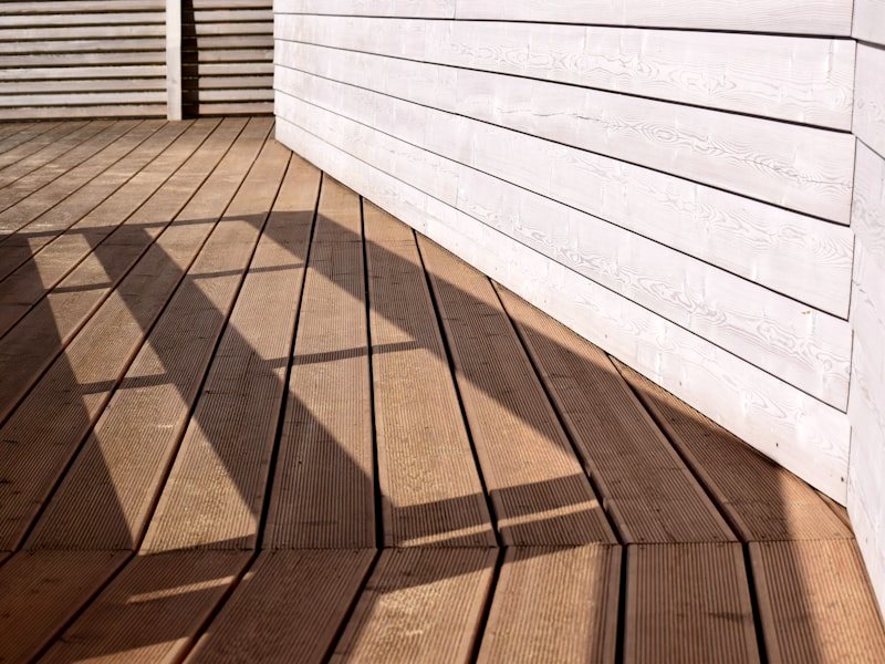 Close view of stained deck boards in low sunlight