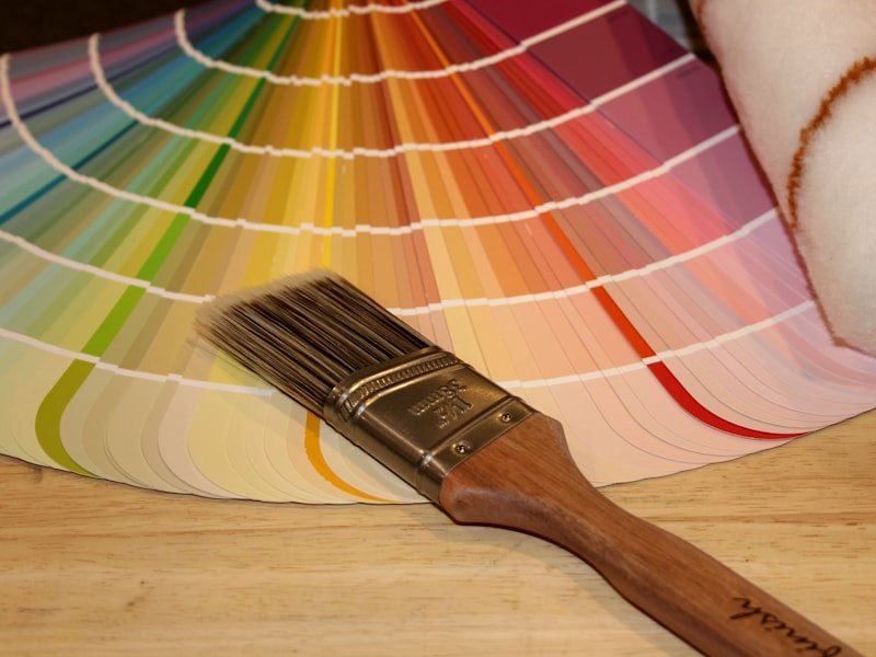 A brush resting beside an open colour fan deck