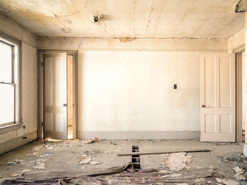 A room stripped back to bare substrate before repair and repainting